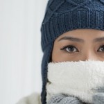 Copy-spaced portrait of a young frozen woman in winter wearing