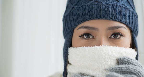 Copy-spaced portrait of a young frozen woman in winter wearing